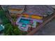Evening aerial view of a backyard with a pool, hot tub, lighting, and outdoor living space at 9865 Bright Angel Way, Las Vegas, NV 89149