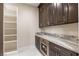 Bar area with custom cabinets, granite countertops, and stainless steel appliances at 9865 Bright Angel Way, Las Vegas, NV 89149
