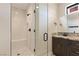 Bathroom featuring tiled walk-in shower, and dark wood vanity with granite countertop at 9865 Bright Angel Way, Las Vegas, NV 89149
