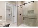 Bright bathroom with glass enclosed shower, granite counters, dark wood vanity, and walk in closet at 9865 Bright Angel Way, Las Vegas, NV 89149