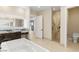 Luxurious bathroom featuring a soaking tub, marble shower, and stylish vanity at 9865 Bright Angel Way, Las Vegas, NV 89149