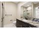 Bright bathroom with granite counters, a dark wood vanity, glass enclosed shower, and tile flooring at 9865 Bright Angel Way, Las Vegas, NV 89149