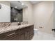 Bathroom vanity features dark cabinetry, marble counter, and modern fixtures at 9865 Bright Angel Way, Las Vegas, NV 89149
