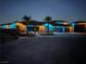 Night shot of a single-story home featuring a three-car garage, palm trees, and holiday lighting at 9865 Bright Angel Way, Las Vegas, NV 89149