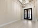 Inviting foyer featuring decorative lighting, tiled flooring, and double-door entry at 9865 Bright Angel Way, Las Vegas, NV 89149