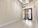 Foyer with decorative light fixture, tile floors, and glass doors at 9865 Bright Angel Way, Las Vegas, NV 89149