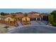 Evening aerial view of home with desert landscaping, lights, and a tile roof at 9865 Bright Angel Way, Las Vegas, NV 89149