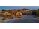 Evening view of a home with desert landscaping, accent lighting, and a tile roof at 9865 Bright Angel Way, Las Vegas, NV 89149