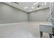 Spacious garage featuring a utility sink, fan, and plentiful recessed lighting illuminating the epoxy floor at 9865 Bright Angel Way, Las Vegas, NV 89149