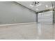 Large garage with epoxy flooring and ample space, featuring an insulated garage door and modern lighting at 9865 Bright Angel Way, Las Vegas, NV 89149