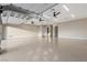 Spacious garage featuring high ceilings, durable flooring, and multiple entry points for versatile use and convenience at 9865 Bright Angel Way, Las Vegas, NV 89149