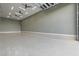 Spacious garage featuring high ceilings, ample lighting, and durable flooring, ready for any project or storage needs at 9865 Bright Angel Way, Las Vegas, NV 89149