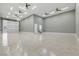 Oversized garage offering high ceilings, durable floors, and convenient wash sink, perfect for various hobbies and storage at 9865 Bright Angel Way, Las Vegas, NV 89149