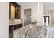 Bar area with stone countertops, glass cabinets, and stainless steel mini-fridge at 9865 Bright Angel Way, Las Vegas, NV 89149
