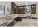 Gourmet kitchen featuring dark wood cabinetry, marble countertops, and stainless steel appliances at 9865 Bright Angel Way, Las Vegas, NV 89149