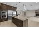 Spacious kitchen showcases stainless steel appliances, a large island, and modern lighting at 9865 Bright Angel Way, Las Vegas, NV 89149