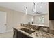Modern kitchen features granite countertops, stainless steel appliances, and stylish pendant lighting at 9865 Bright Angel Way, Las Vegas, NV 89149