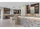 Modern kitchen featuring sleek cabinetry, stone accents, and stylish pendant lighting at 9865 Bright Angel Way, Las Vegas, NV 89149