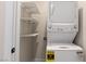 Laundry room with stacked washer and dryer, and shelving for storage at 9865 Bright Angel Way, Las Vegas, NV 89149
