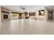 Spacious living room with stone fireplace, light tile flooring, and access to the outdoor pool area at 9865 Bright Angel Way, Las Vegas, NV 89149