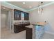 Entertain in style with a wet bar featuring granite countertops, pendant lighting, and display cabinets with lighting at 9865 Bright Angel Way, Las Vegas, NV 89149