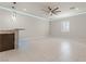 Large living area with tile flooring, a ceiling fan, and a stylish bar area with stone accents at 9865 Bright Angel Way, Las Vegas, NV 89149