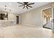 Open-concept living room with sleek tile flooring, modern lighting, and a stylish stone accent wall at 9865 Bright Angel Way, Las Vegas, NV 89149