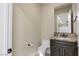 Elegant powder room featuring marble countertop, dark wood vanity, and modern fixtures, providing a stylish and convenient space at 9865 Bright Angel Way, Las Vegas, NV 89149
