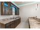 Gourmet wet bar with granite countertops, custom cabinetry and glass shelving with accent lighting at 9865 Bright Angel Way, Las Vegas, NV 89149