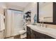 Bathroom with white countertop, dark wood cabinets, and a shower-tub combination at 987 Wembly Hills Pl, Henderson, NV 89011