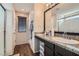 Bathroom featuring granite countertops, wood floors, a glass shower, and ample counter space at 987 Wembly Hills Pl, Henderson, NV 89011