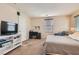 Comfortable bedroom features neutral carpeting, a work desk, and bright, natural light at 987 Wembly Hills Pl, Henderson, NV 89011