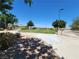 Lush green community green space, complemented by mature trees, under a clear, sunny sky at 987 Wembly Hills Pl, Henderson, NV 89011