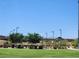 Community park with grassy areas, shade structures, and walking paths under a clear sky at 987 Wembly Hills Pl, Henderson, NV 89011