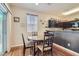 The dining area has a round table with decorative chairs, perfect for Gathering meals at 987 Wembly Hills Pl, Henderson, NV 89011