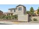 Attractive two-story home featuring desert-friendly landscaping, a white privacy fence, and mature shade trees at 987 Wembly Hills Pl, Henderson, NV 89011