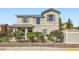 Well-maintained two-story home with mature landscaping and blooming bushes adding curb appeal at 987 Wembly Hills Pl, Henderson, NV 89011