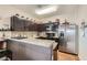 Kitchen boasts stainless steel appliances, granite countertops, and dark wood cabinetry at 987 Wembly Hills Pl, Henderson, NV 89011