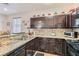 Well-appointed kitchen features granite counters, stainless steel appliances, and dark cabinetry at 987 Wembly Hills Pl, Henderson, NV 89011