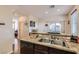 This kitchen offers a view of the backyard, granite counters, and stainless steel appliances at 987 Wembly Hills Pl, Henderson, NV 89011