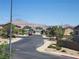 A view of a suburban neighborhood with desert landscaping and mountains in the distance at 987 Wembly Hills Pl, Henderson, NV 89011