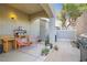 Relaxing outdoor patio featuring a grill, work station, and comfortable seating, ideal for casual entertaining at 987 Wembly Hills Pl, Henderson, NV 89011