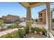 Covered front porch with potted plants and a view of the street and neighboring homes at 987 Wembly Hills Pl, Henderson, NV 89011
