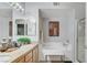 Bright bathroom features a double vanity, a soaking tub, and a separate glass-enclosed shower for convenience at 9975 Peace Way # 1069, Las Vegas, NV 89147