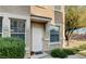 Exterior view of a condo featuring neutral tones, mature landscaping, and a covered entryway at 9975 Peace Way # 1069, Las Vegas, NV 89147