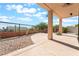 Covered patio leads to backyard water feature surrounded by desert landscaping and palm trees at 1016 Eaglewood Dr, Las Vegas, NV 89144