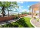 Backyard featuring lush desert landscaping, turf, and a water feature at 1016 Eaglewood Dr, Las Vegas, NV 89144