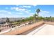 Balcony view featuring neighborhood homes, palm trees, and clear blue skies with scattered clouds at 1016 Eaglewood Dr, Las Vegas, NV 89144