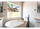 Bright bathroom featuring a modern soaking tub and large window with natural light at 1016 Eaglewood Dr, Las Vegas, NV 89144
