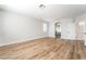 Spacious bedroom with wood-look floors, natural light, and ensuite bathroom at 1016 Eaglewood Dr, Las Vegas, NV 89144